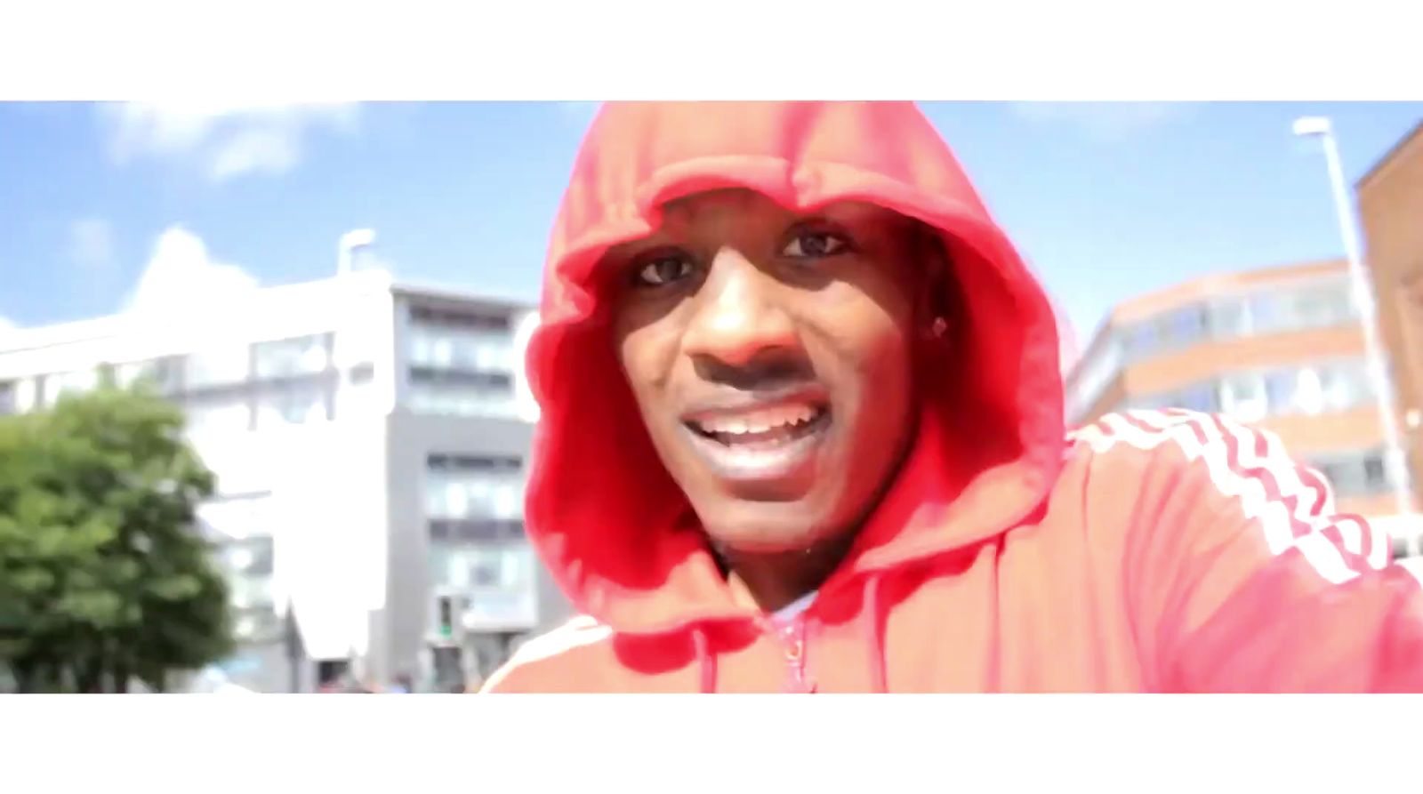 a man in a red hoodie is smiling