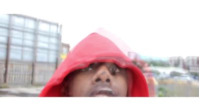 a man in a red hoodie making a face