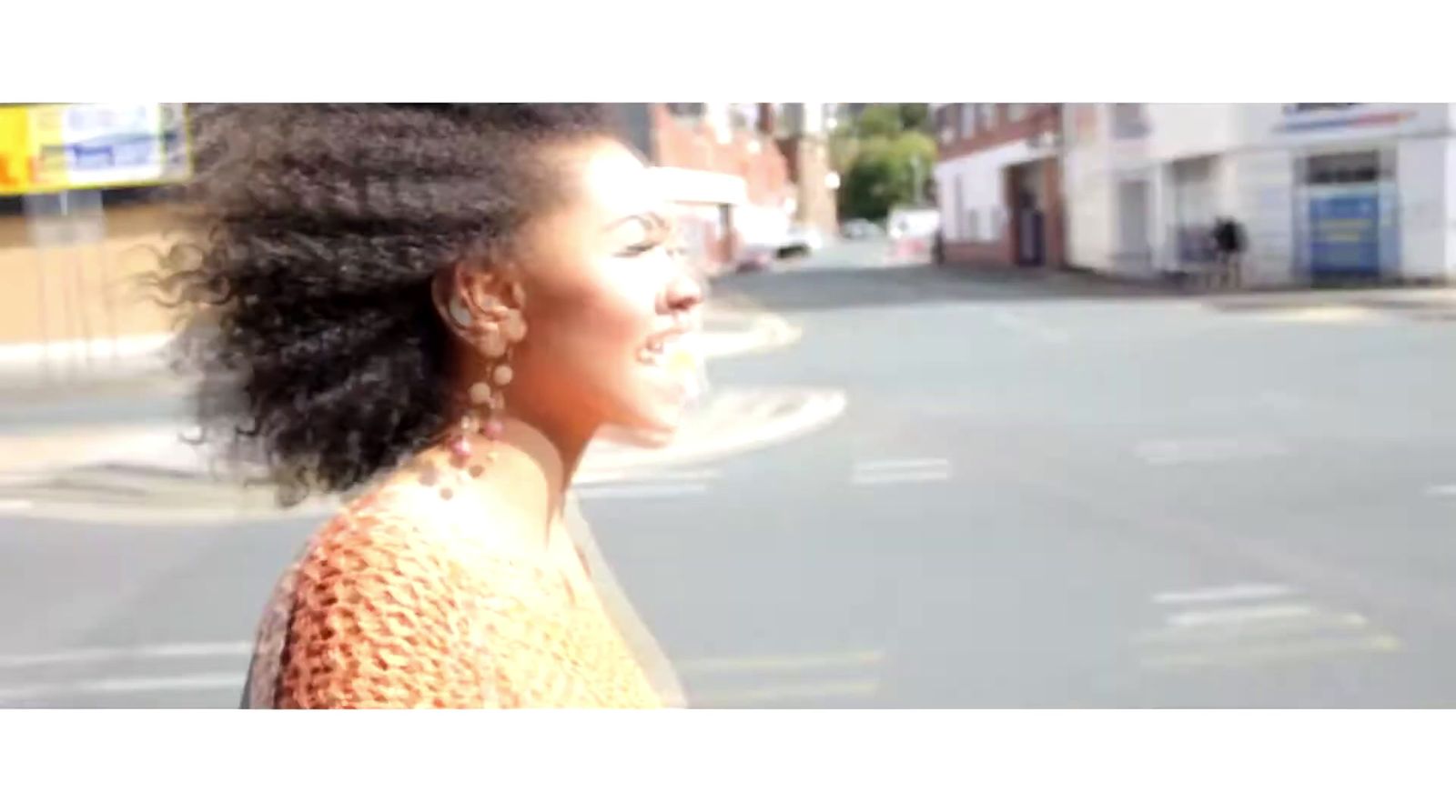 a woman standing on the side of a road