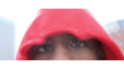 a woman in a red hoodie looking at the camera