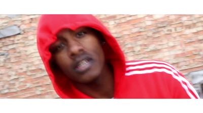 a man in a red hoodie looking at the camera