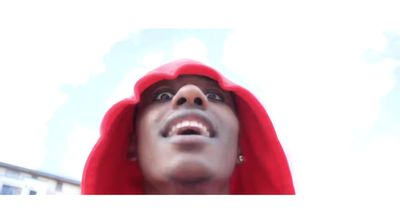 a man in a red hoodie looking up into the sky