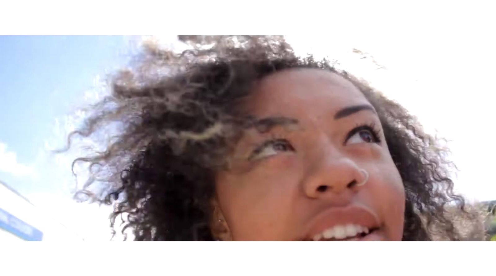 a close up of a person with curly hair