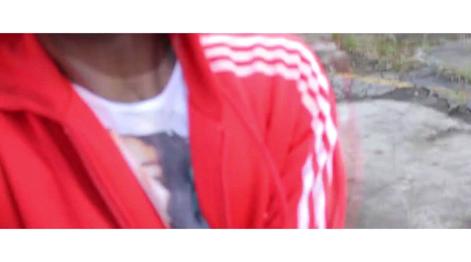 a person wearing a red jacket and a white shirt