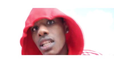 a man in a red hoodie looking at the camera