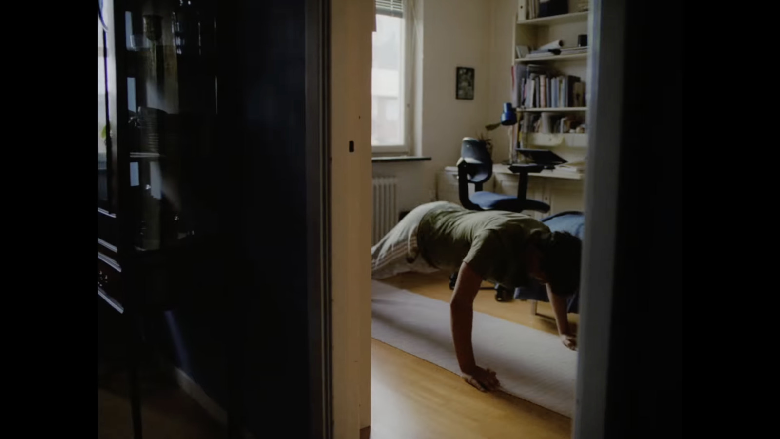 a room with a bed and a book shelf