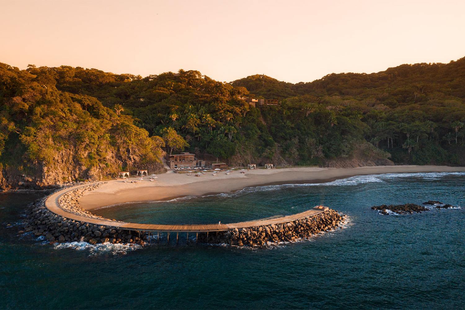 an aerial view of a beach and a pier