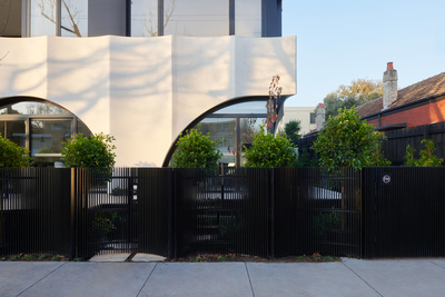 a white building with a black fence in front of it