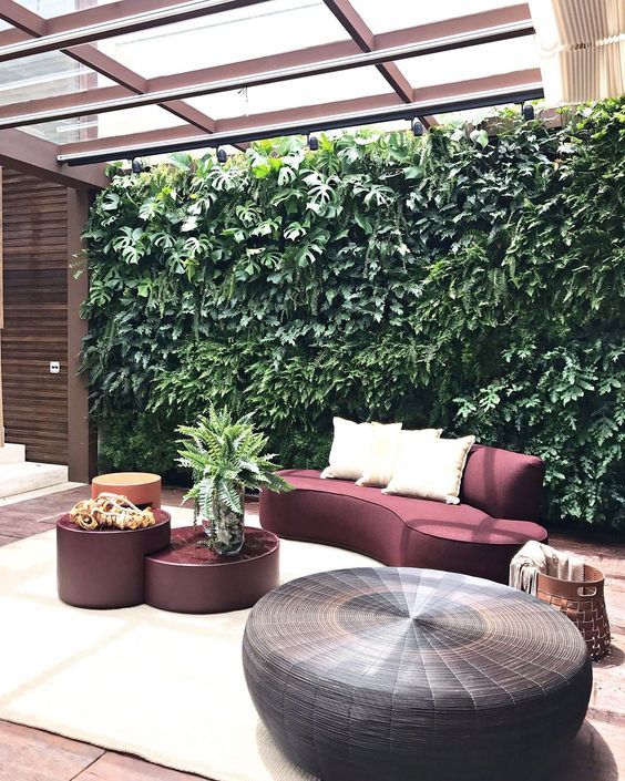 a living room filled with furniture and a green wall