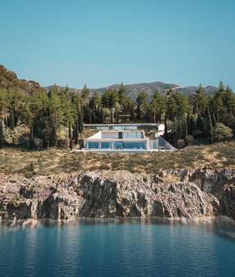 a house on a cliff overlooking a body of water