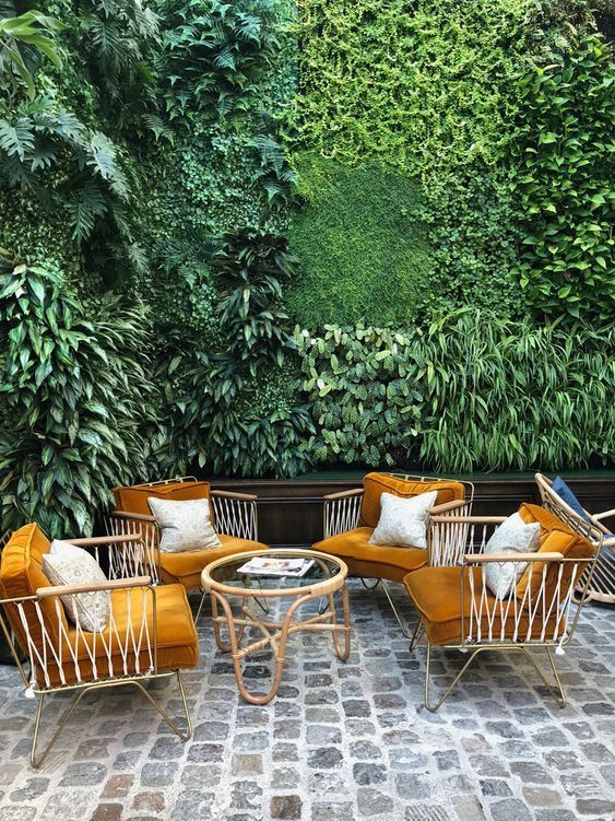 a living room filled with lots of green plants