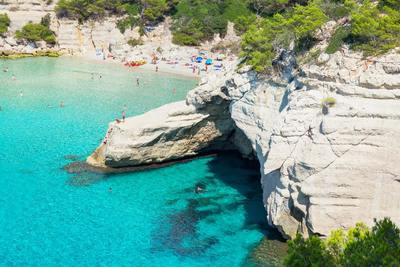 a group of people are swimming in the blue water