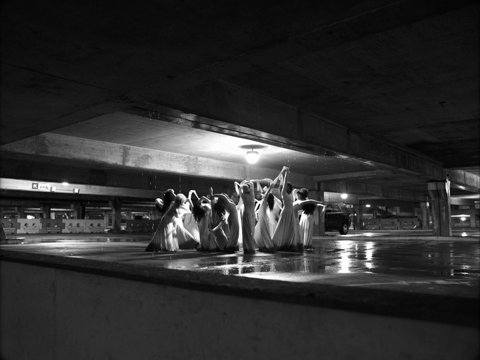 a black and white photo of a group of women in long dresses