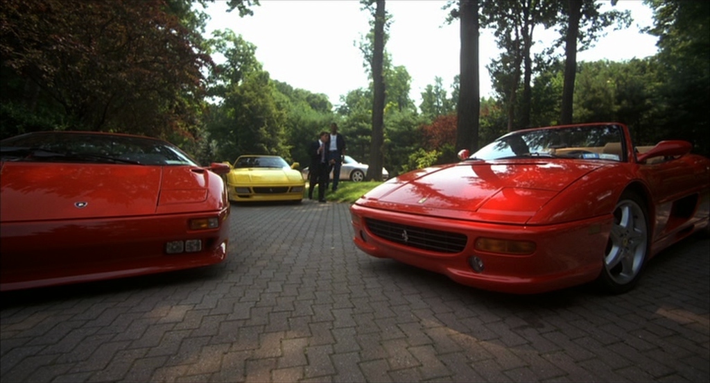 a couple of red sports cars parked next to each other