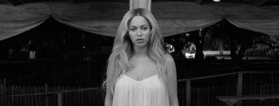 a black and white photo of a woman in a dress