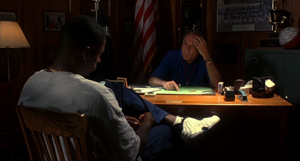 two men sitting at a table in a dark room