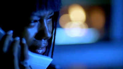 a woman talking on a cell phone in the dark