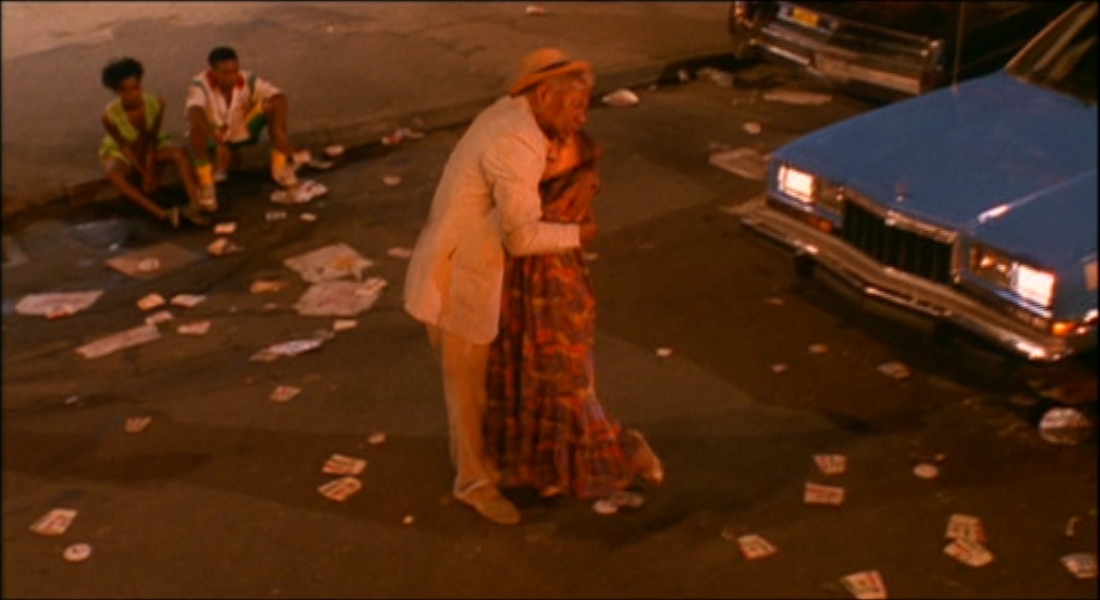 a man and a woman standing on the side of a road