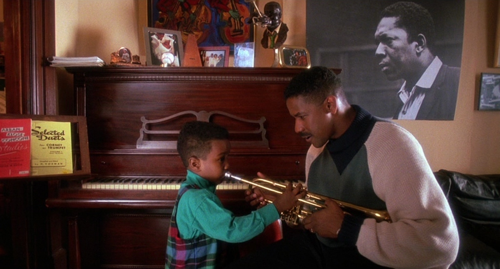 a man playing a trumpet with a young boy