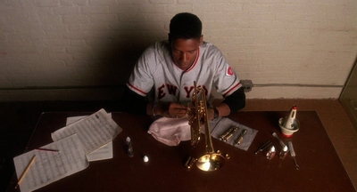 a man sitting at a table with a saxophone