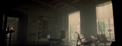 a woman sitting in a chair in front of a window