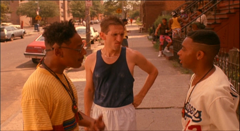 a group of men standing next to each other on a street