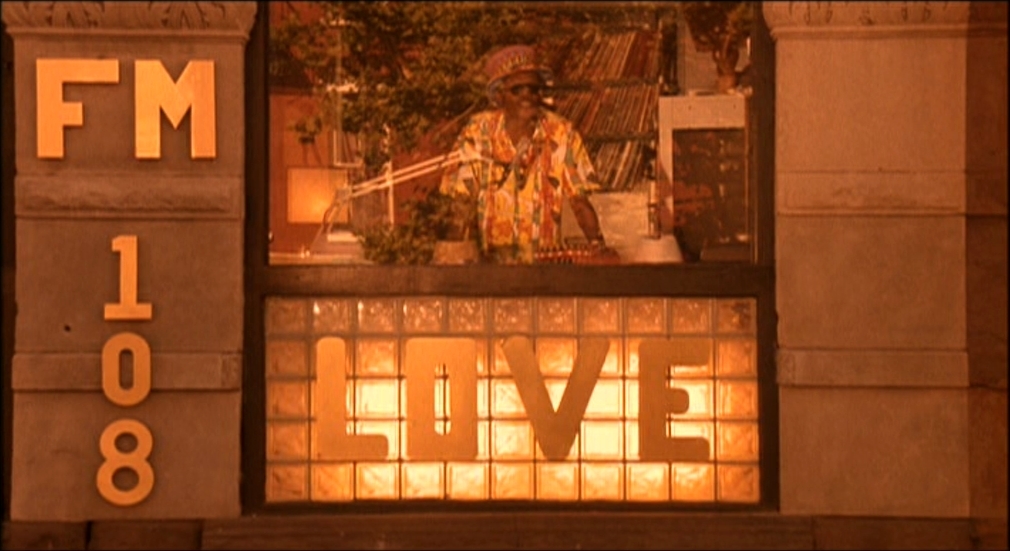 a man standing in front of a window with the words f m love on it