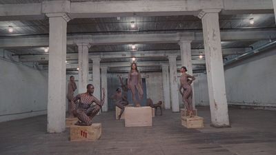 a group of mannequins sitting in a warehouse