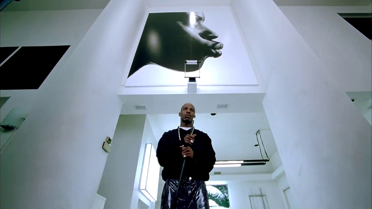 a man standing in a hallway with a cell phone