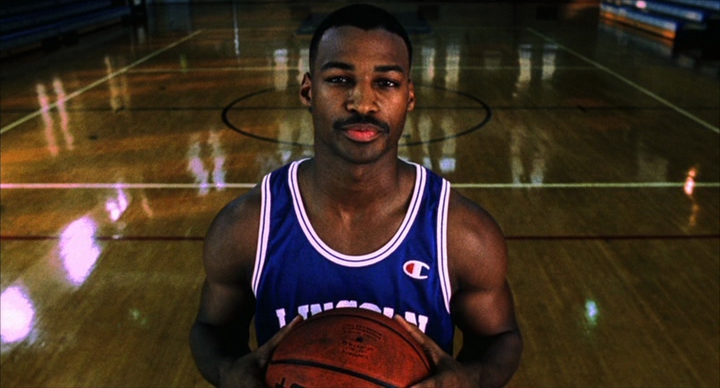 a man holding a basketball on a basketball court