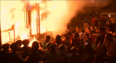 a group of people standing around a fire