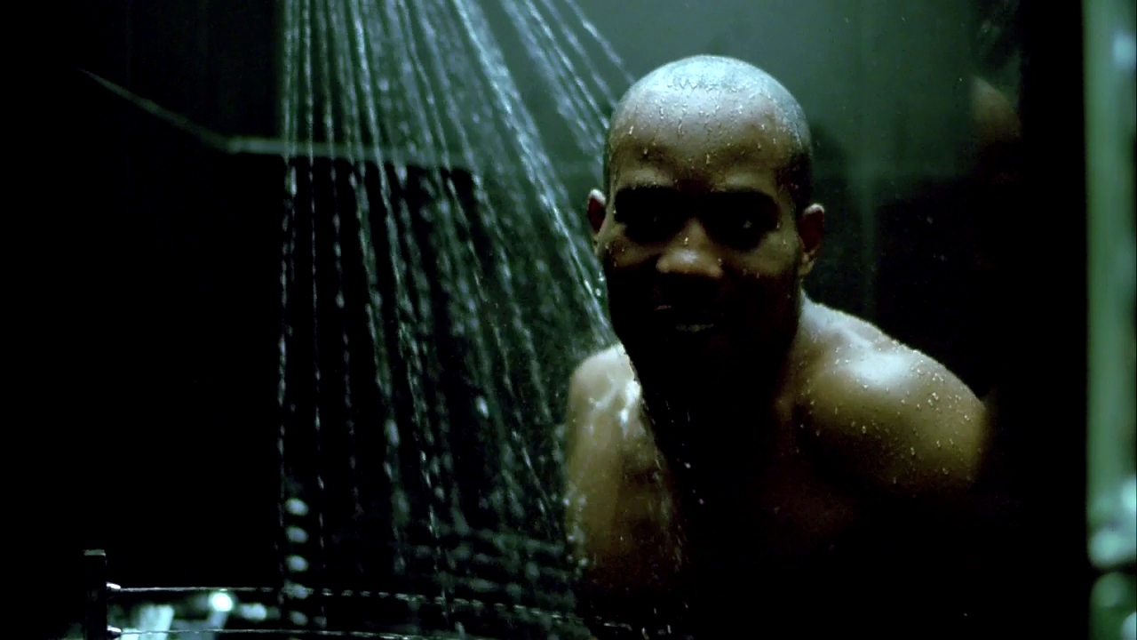 a man standing in a shower in the dark