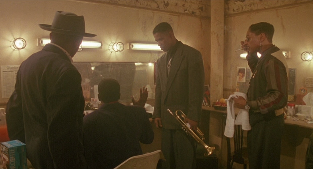 a group of men standing in a bathroom next to each other