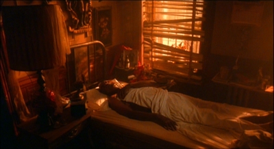 a person laying on a bed in a dimly lit room