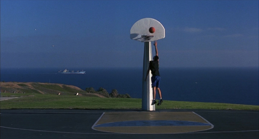 a man is playing basketball on a basketball court