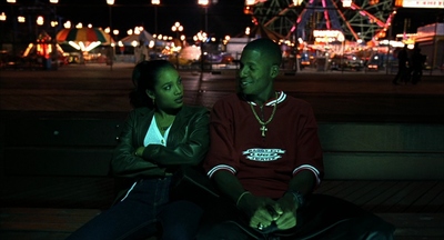 a man and a woman sitting on a bench at night