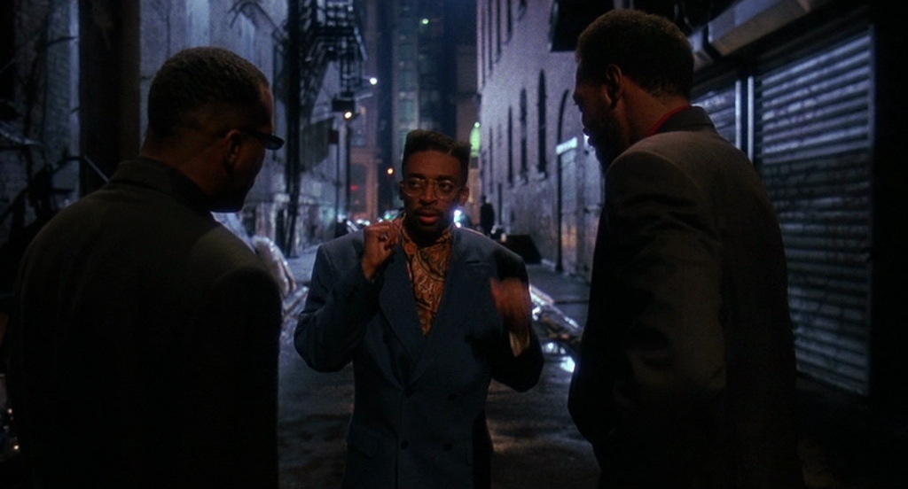 a group of men standing on a city street