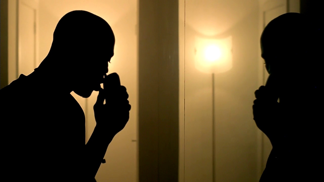 a man standing in front of a mirror holding a cell phone