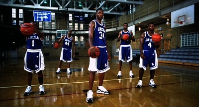 a group of young men standing on top of a basketball court