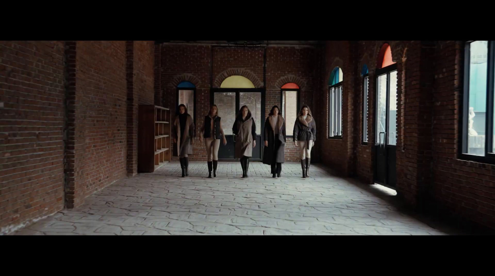 a group of women walking down a hallway