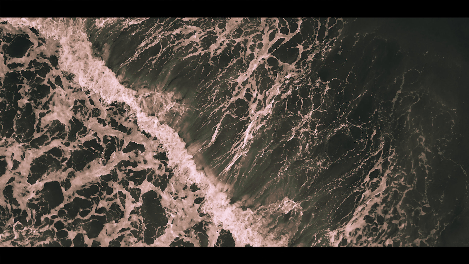 a black and white photo of the ocean waves