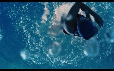 a woman in a bikini swimming in the ocean