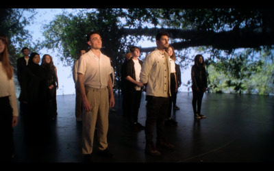 a group of people standing in front of a screen