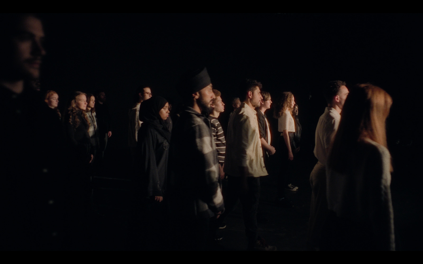 a group of people standing in a dark room