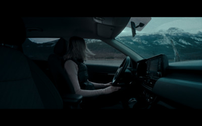 a woman sitting in the driver's seat of a car