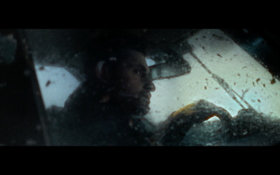 a man driving a car in the rain