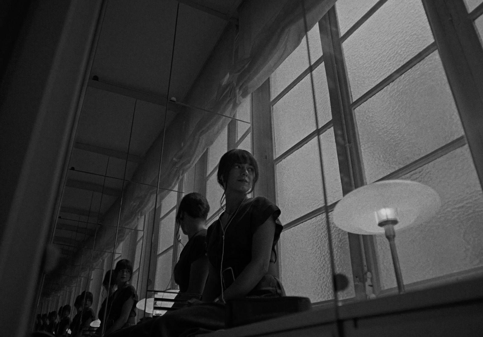 a black and white photo of people sitting in a room