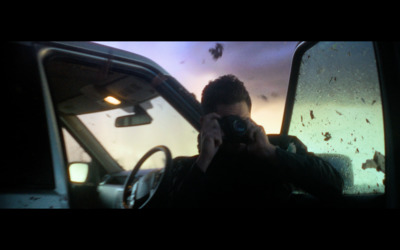 a man is taking a picture of himself in a car