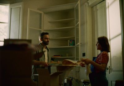 a man standing next to a woman in a kitchen