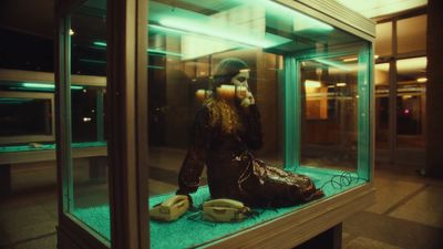 a display case with a woman talking on a cell phone